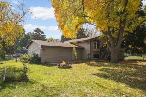 Another view of the home's exterior and spacious yard with mature trees.