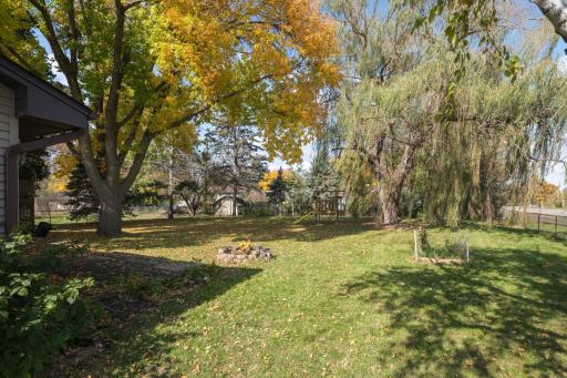 Enjoy the outdoors in this generously sized backyard with mature shade trees and room to play!