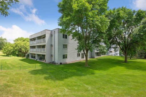 The building is surrounded by a lot of green space.