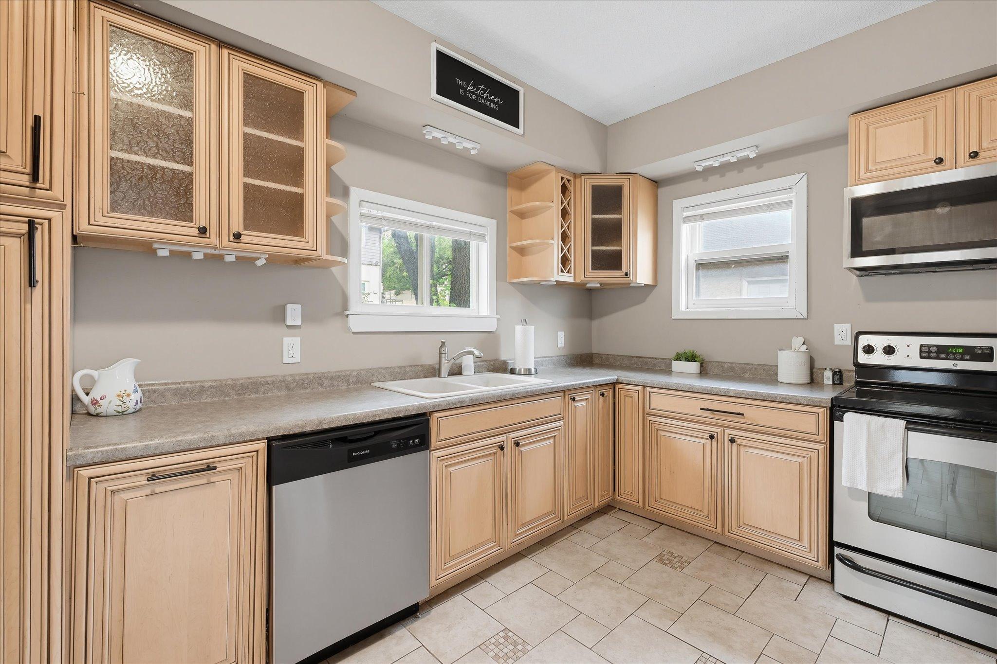Warm wood cabinetry, spacious countertops, and newer stainless steel appliances come together beautifully in this stylish kitchen!