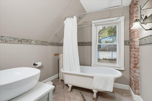 Charming clawfoot tub adds a timeless touch to the full bathroom