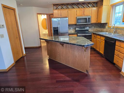 Pantry door, Kitchen area, breakfast bar with granite countertops, stainless steel appliances