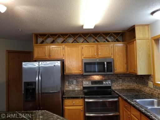 Wine rack over the refrigerator and microwave