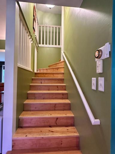 Just off the kitchen is the stairs leading to the bedrooms upstairs.