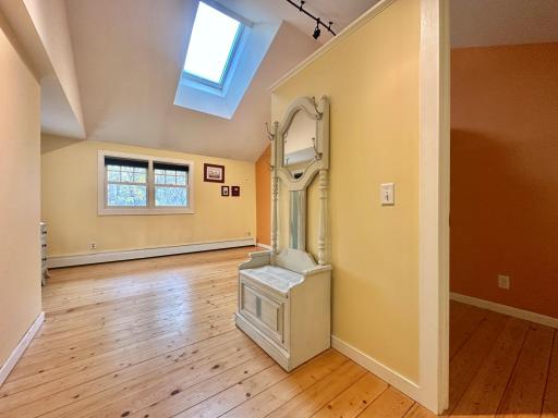 The first of four bedrooms up is this awesome room. Walk in closet to the right. Natural light from above in the sky light as well as the double window.