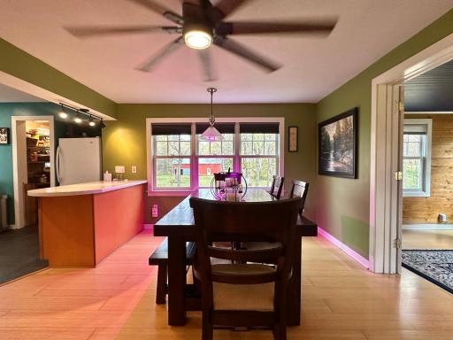 This dining room is spacious and has a large ceiling fan to move the air in this central room of the house.
