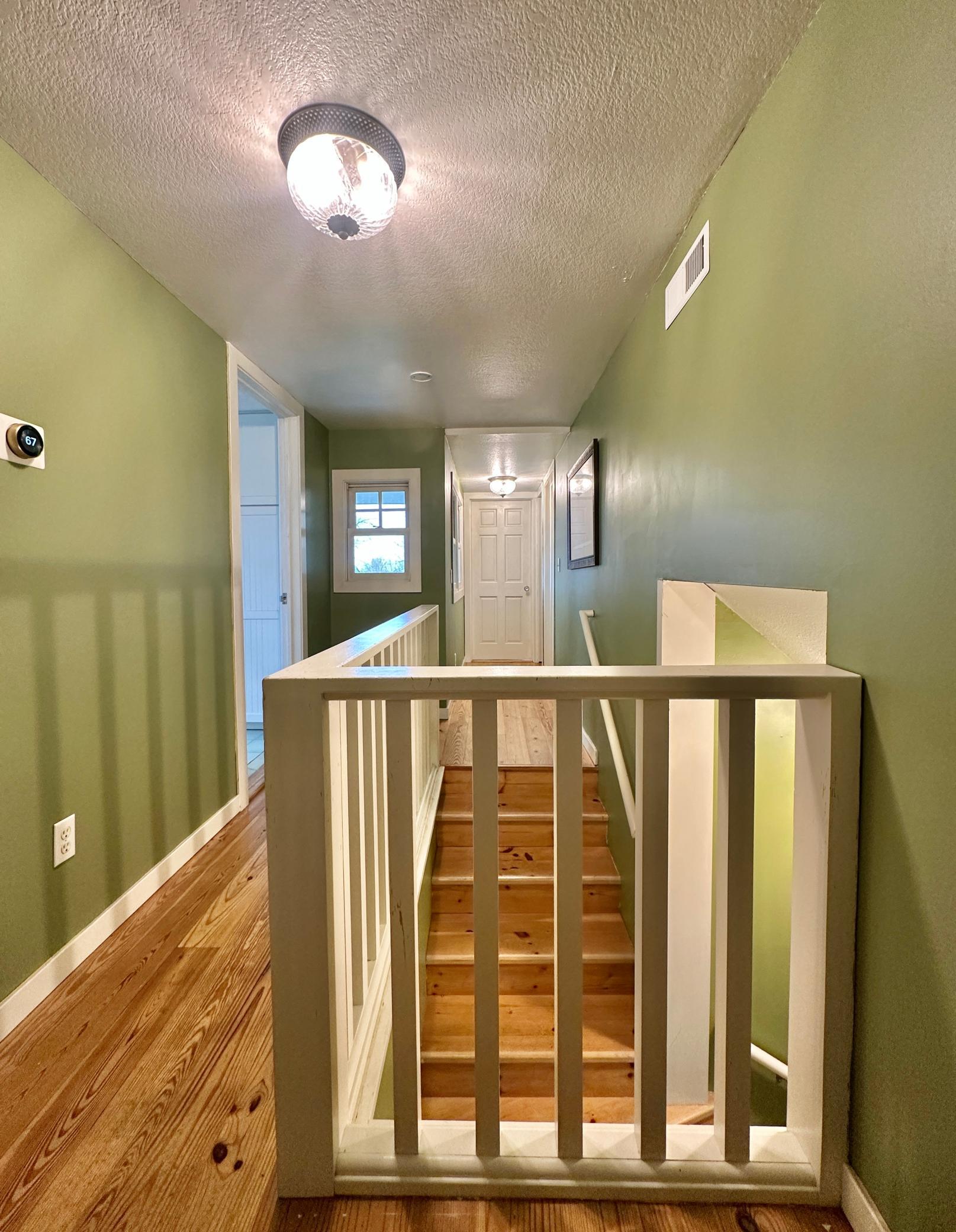 The hall and stairs that give access to the upstairs.