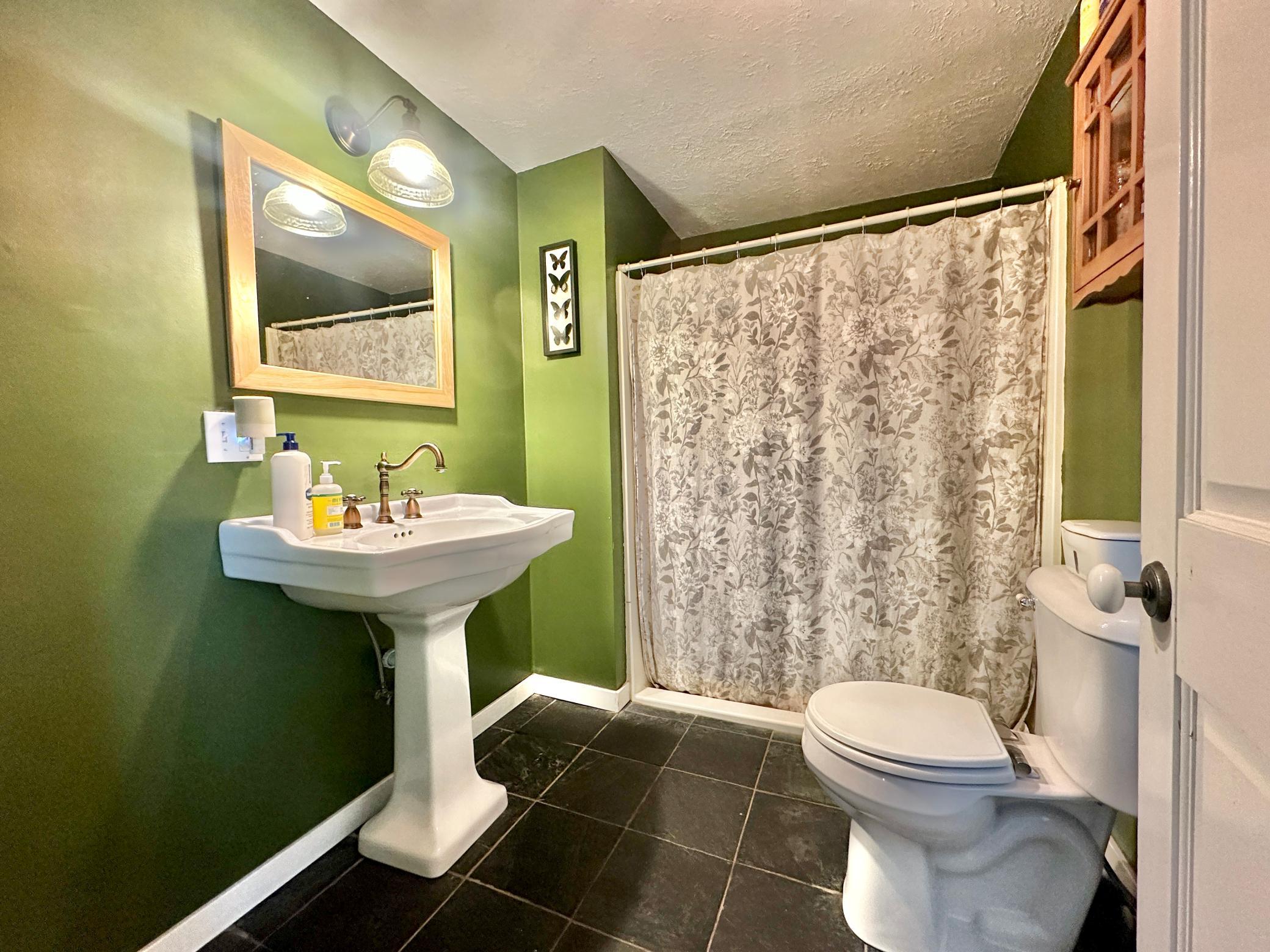 Just off the kitchen is the 3/4 bath serving the main level.