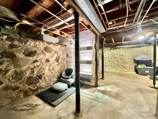 The basement has a solid stone foundation and most of it has been sprayed with spray foam.