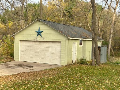 The two car garage has a shed off the back that is attached and has a sliding door on the side.