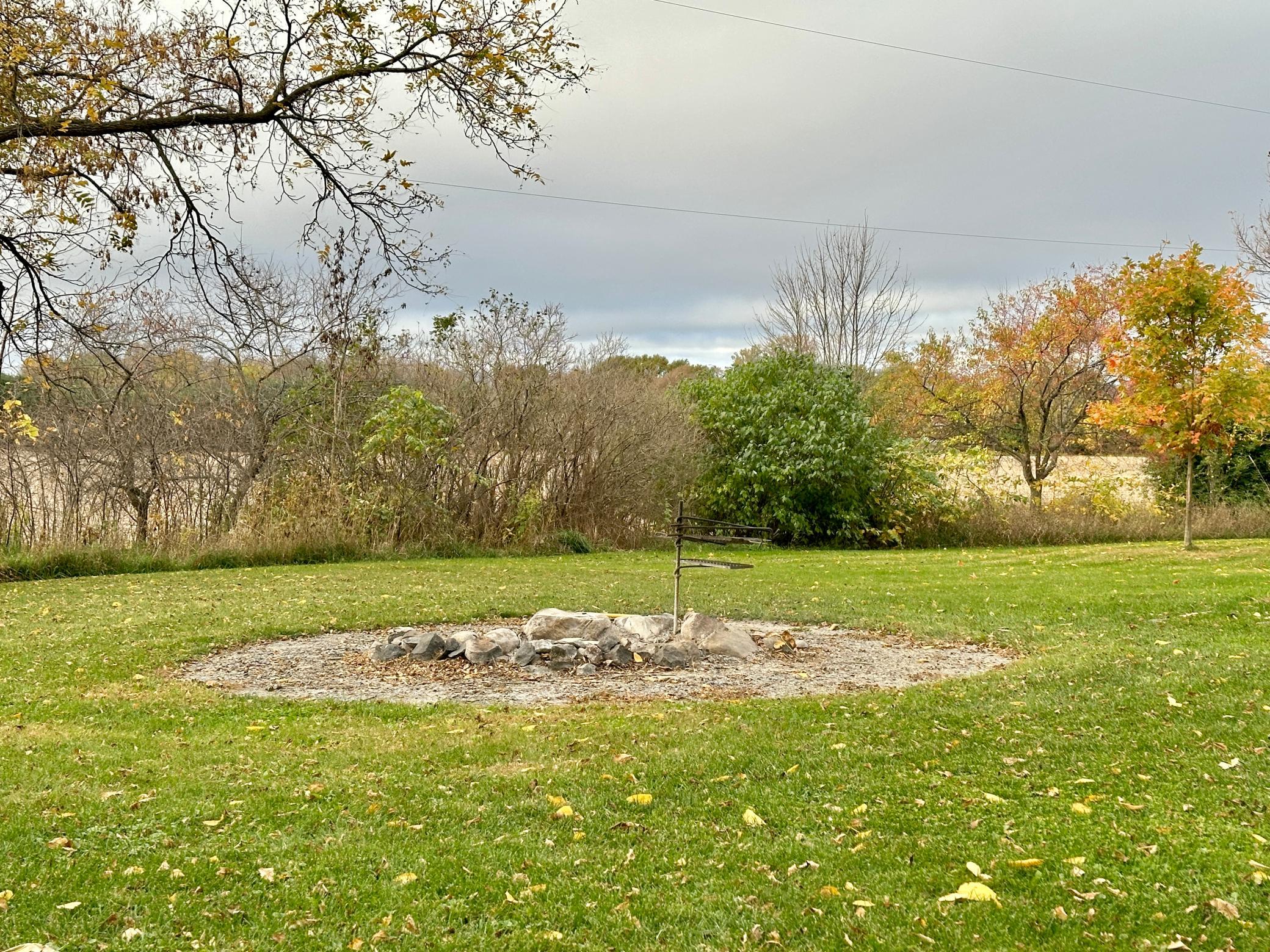 On the same side of the house in back is the fire pit that brings friends and family together.