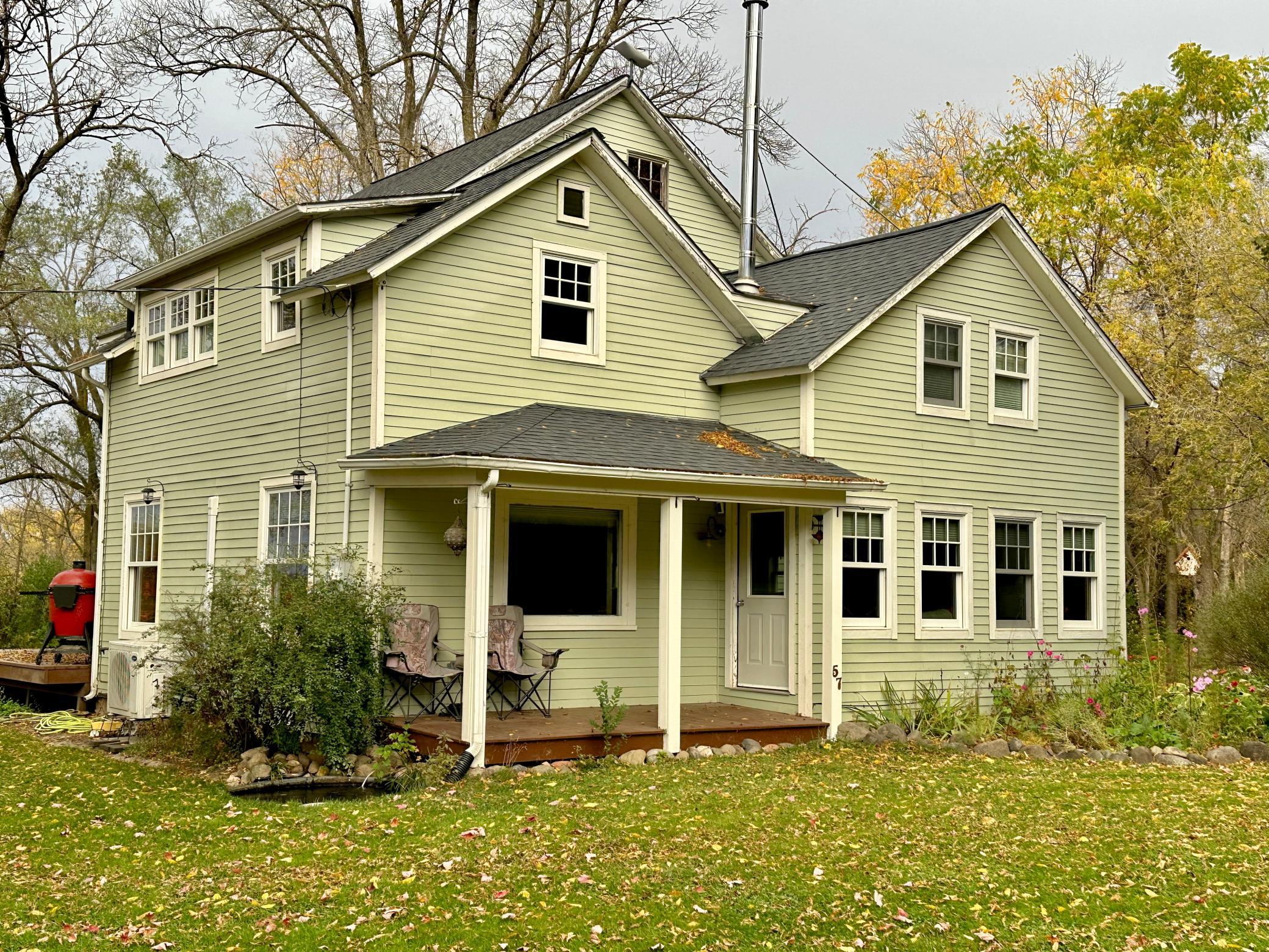 3 porches on this home, this covered porch is on the front of the home and enjoys a beautiful spacious yard.
