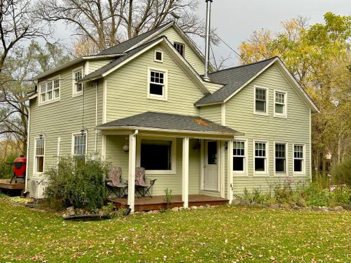 3 porches on this home, this covered porch is on the front of the home and enjoys a beautiful spacious yard.