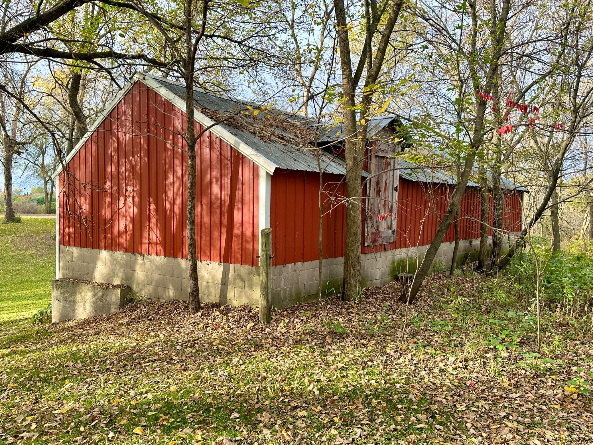 A look at the back of the barn reveals a door to the upper level to utilize the way you see fit.
