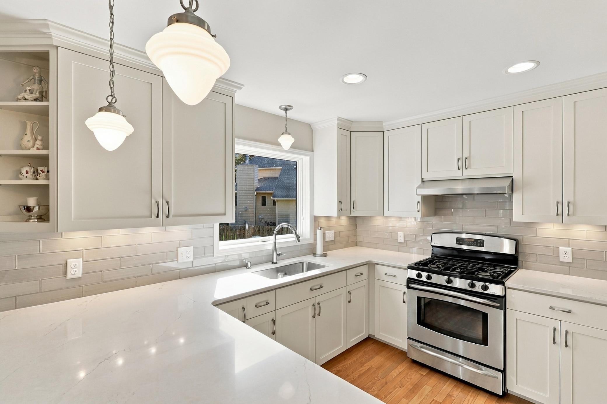 Solid-surface countertops complement the custom cabinetry.