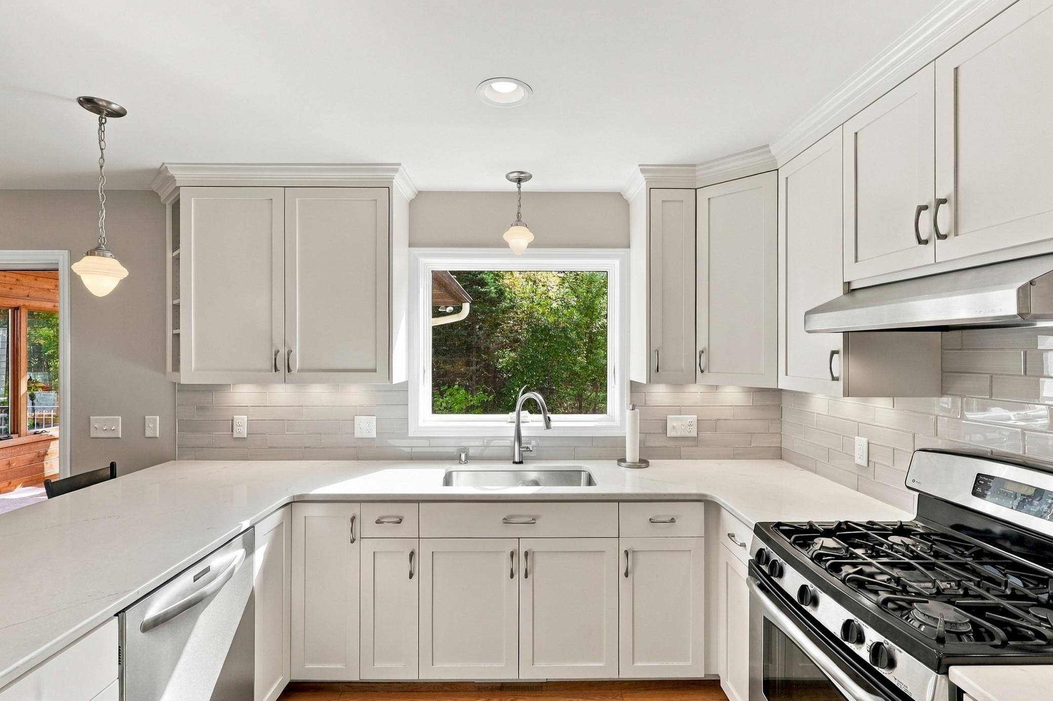 Updated custom kitchen featuring white-enameled cabinetry.