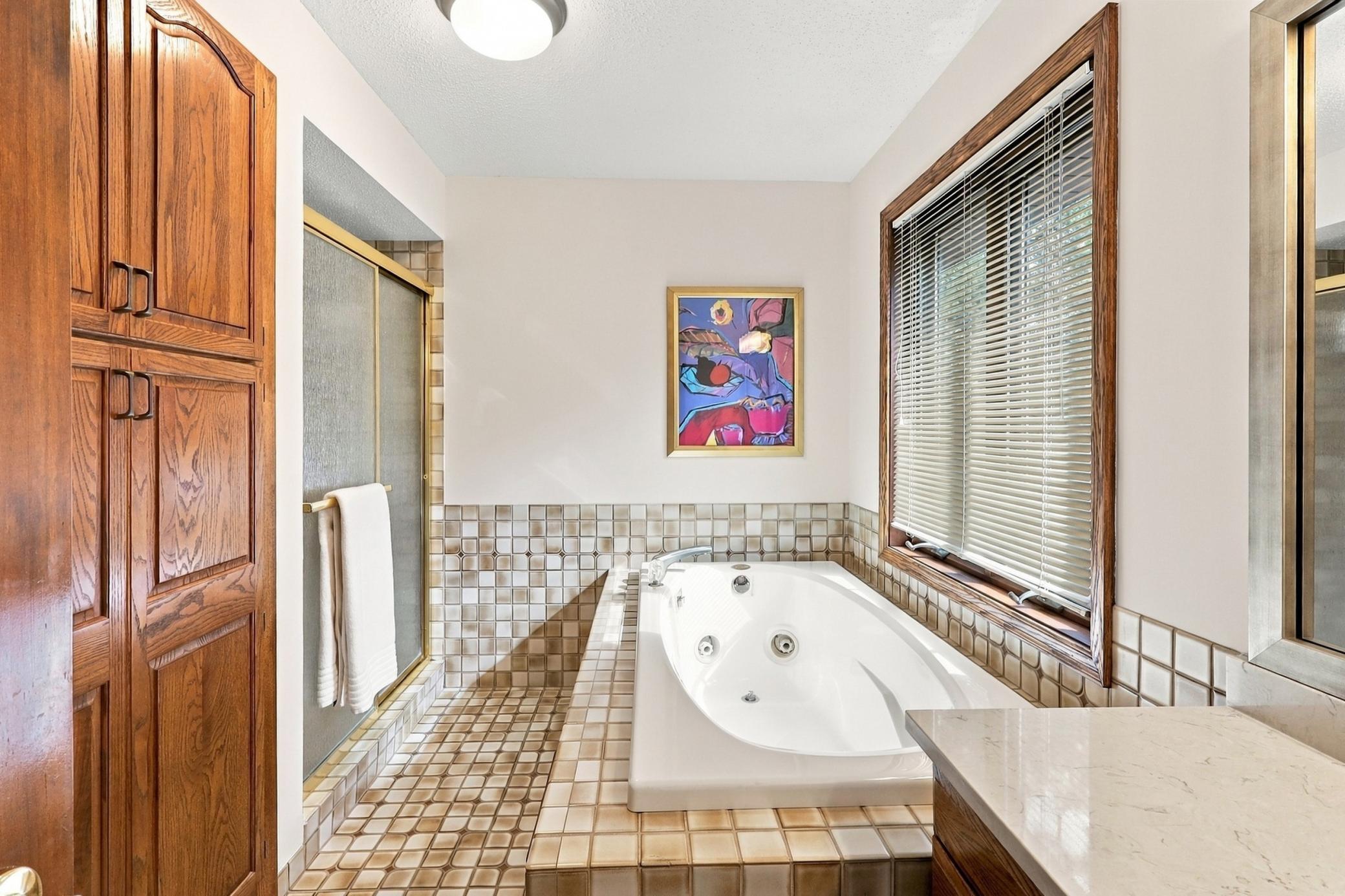 Relax and unwind in the primary suite's private bath, complete with a separate whirlpool tub and shower.