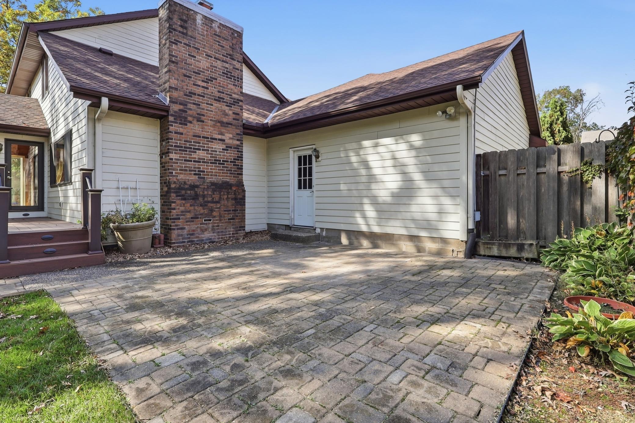 Backyard patio offers additional space for outdoor relaxation and entertaining.