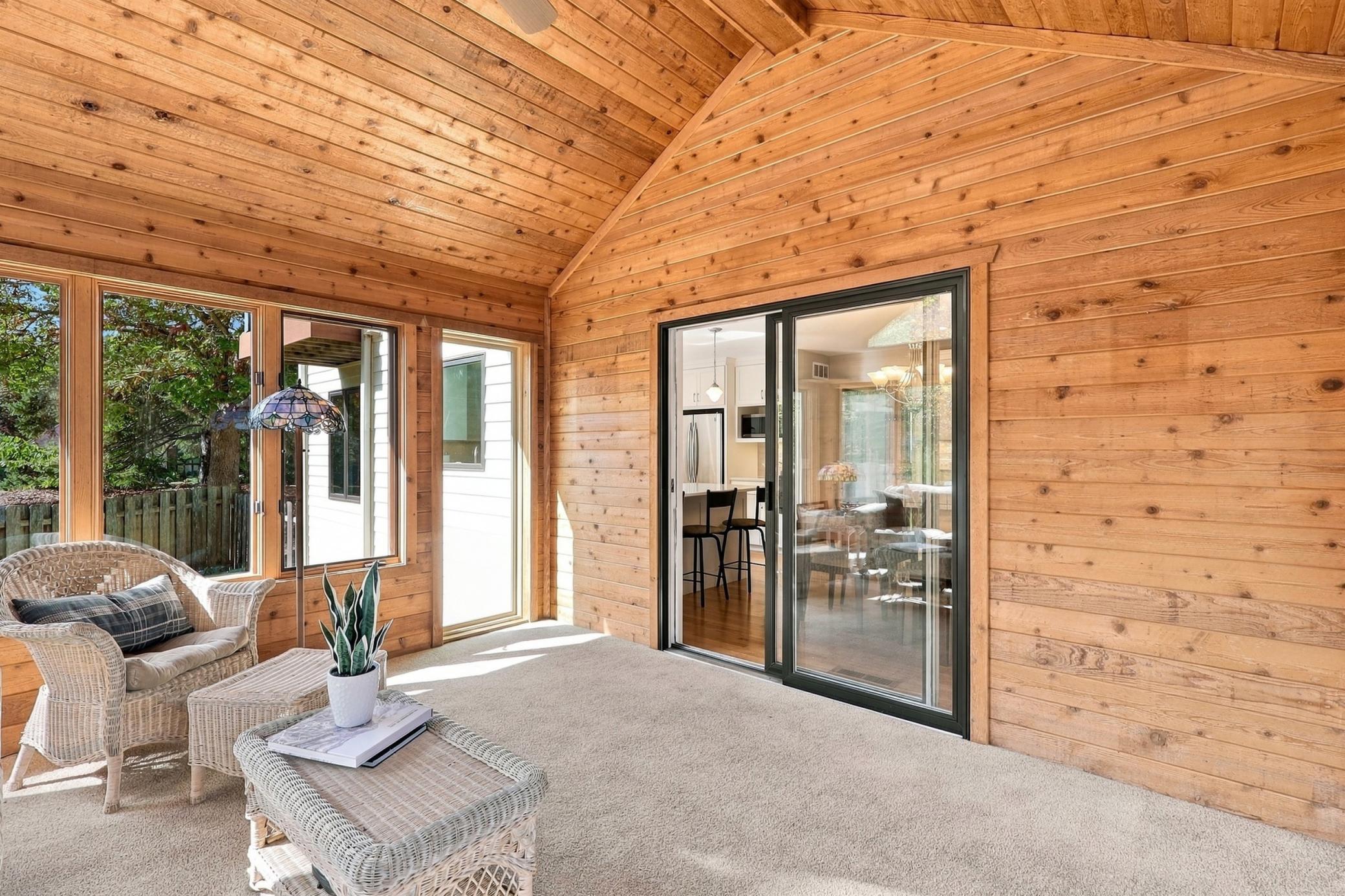 Warm cedar finishes create a distinctive sunroom atmosphere.