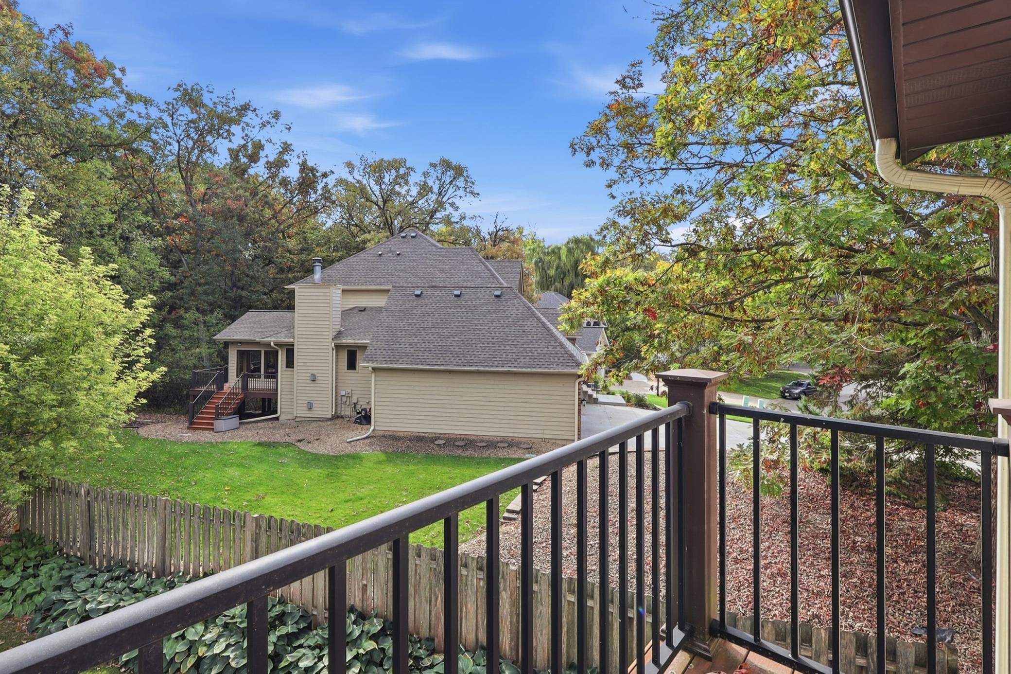 Private balcony off the primary suite offers peaceful views overlooking the backyard.