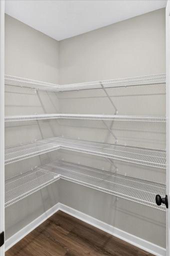 PHOTO OF A DIFFERENT HOME WITH SIMILAR PLAN & FINISHES. Plan and finishes may vary. Kitchen Walk-in Pantry.