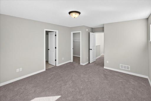 PHOTO OF A DIFFERENT HOME WITH SIMILAR PLAN & FINISHES. Plan and finishes may vary. Primary Suite.