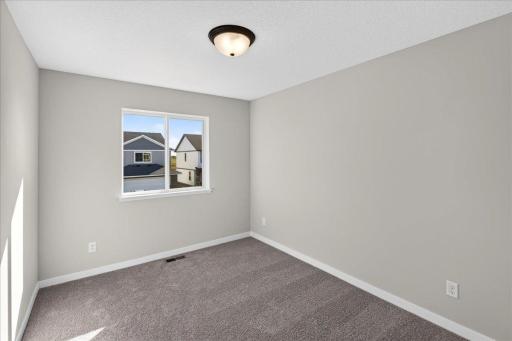 PHOTO OF A DIFFERENT HOME WITH SIMILAR PLAN & FINISHES. Plan and finishes may vary. Bedroom 2.