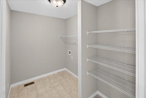 PHOTO OF A DIFFERENT HOME WITH SIMILAR PLAN & FINISHES. Plan and finishes may vary. Upper Floor Laundry Room.