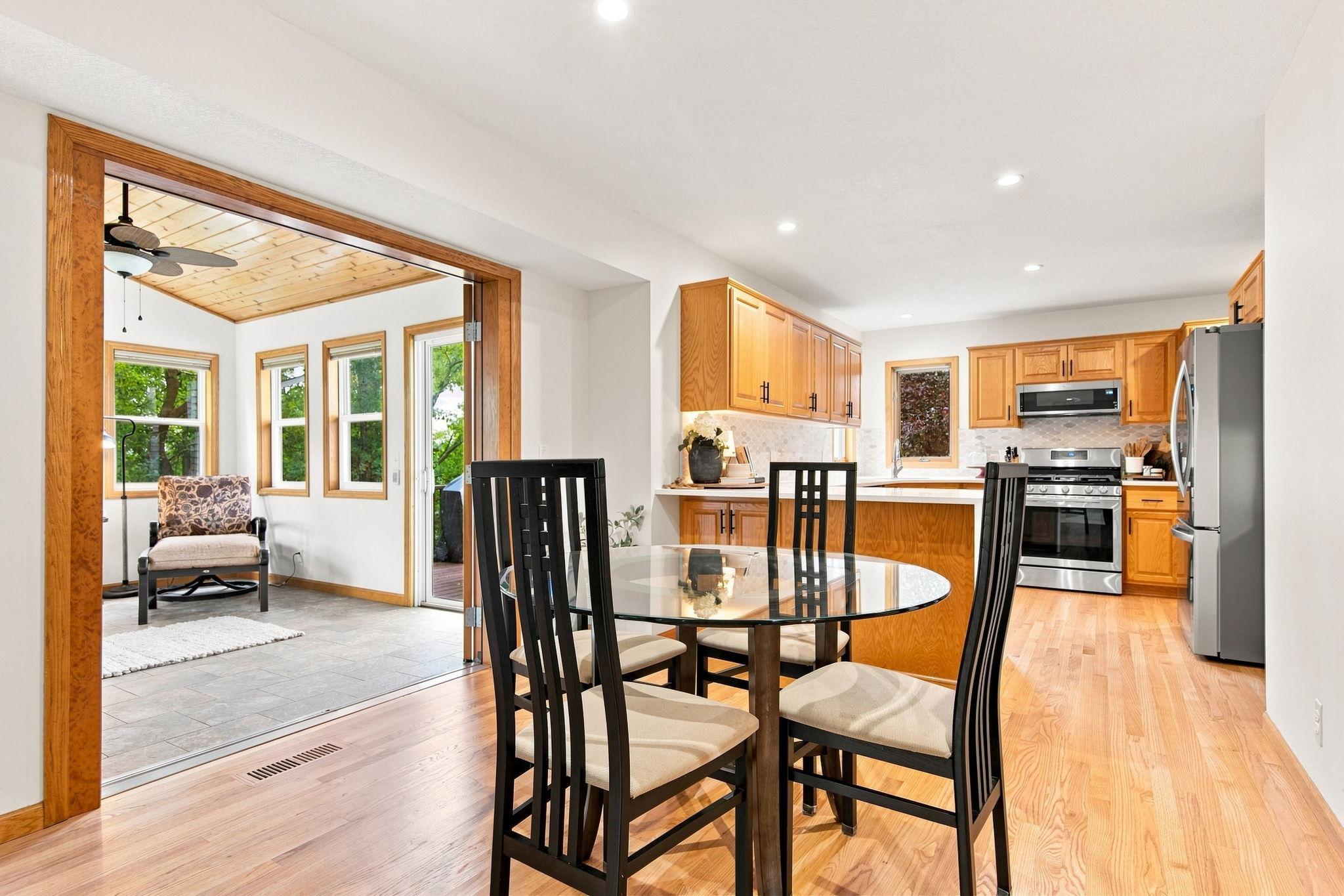 Dining room off the kitchen flows seamlessly into the three-season porch.
