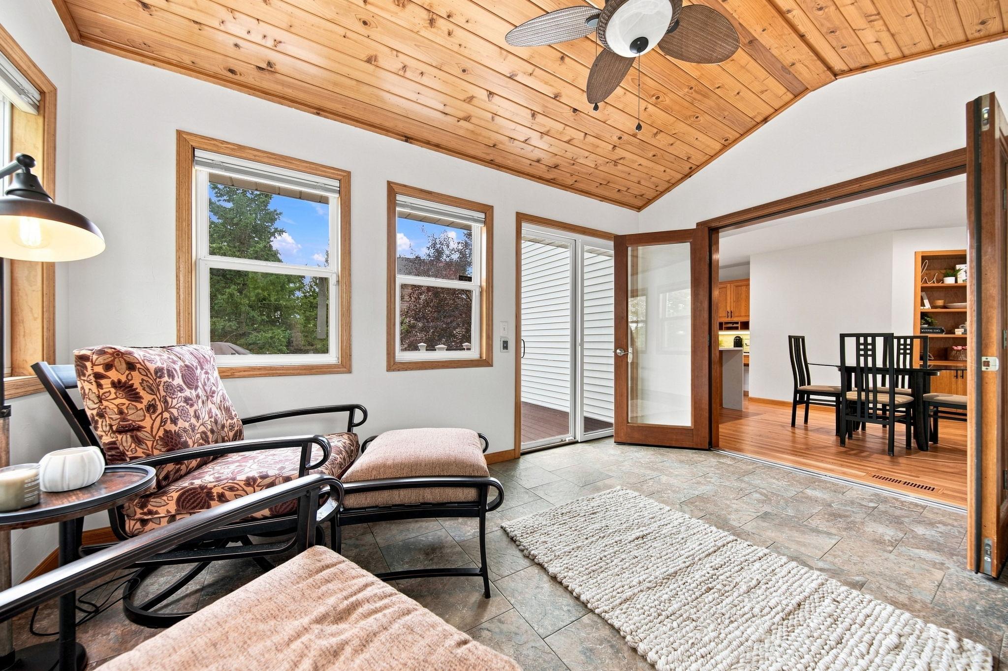 Freshly painted three-season porch opens directly to the Trex deck overlooking the private backyard.
