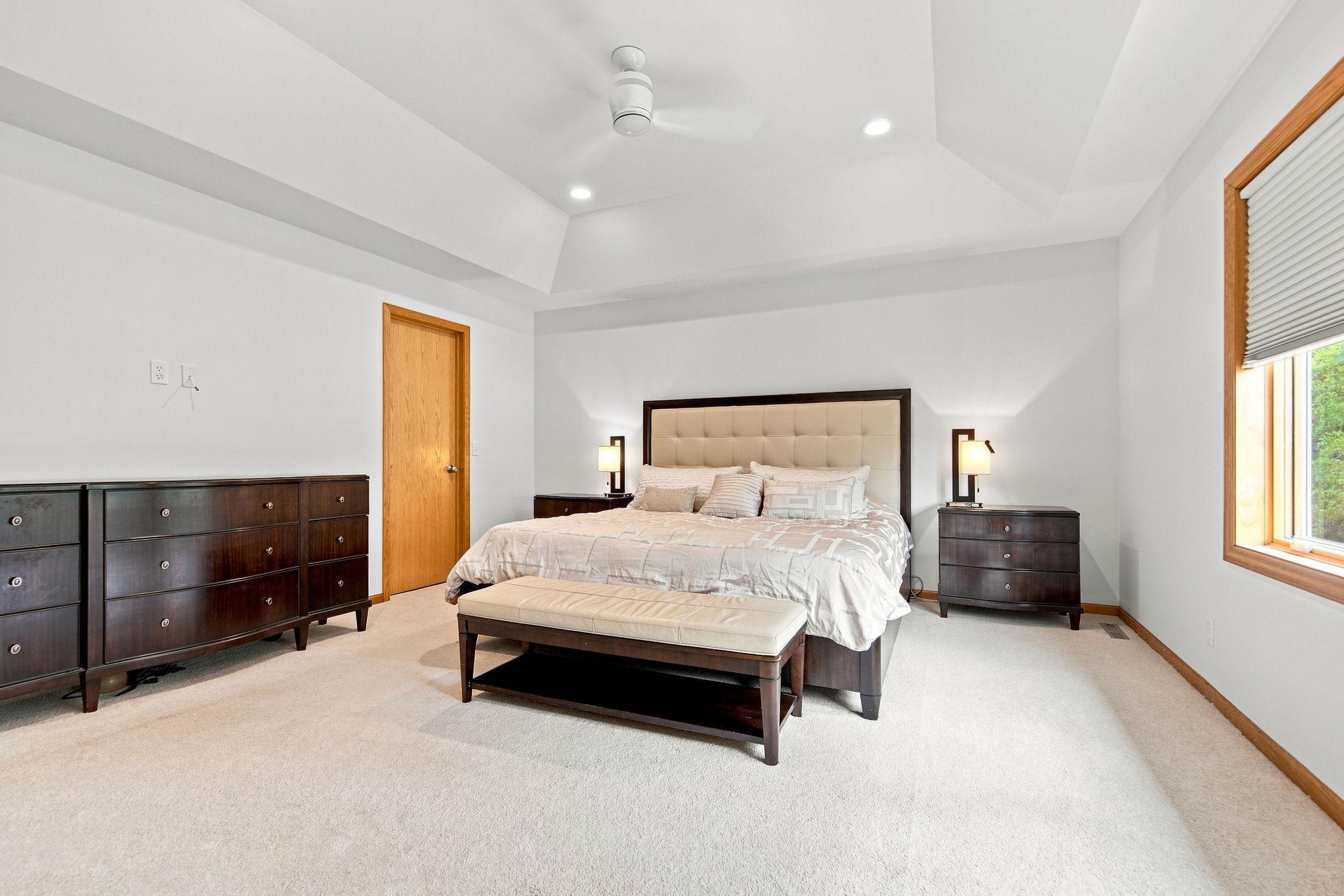 Spacious primary retreat has been freshly painted and featuring a vaulted ceiling and double closets.