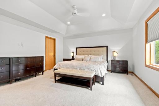 Spacious primary retreat has been freshly painted and featuring a vaulted ceiling and double closets.