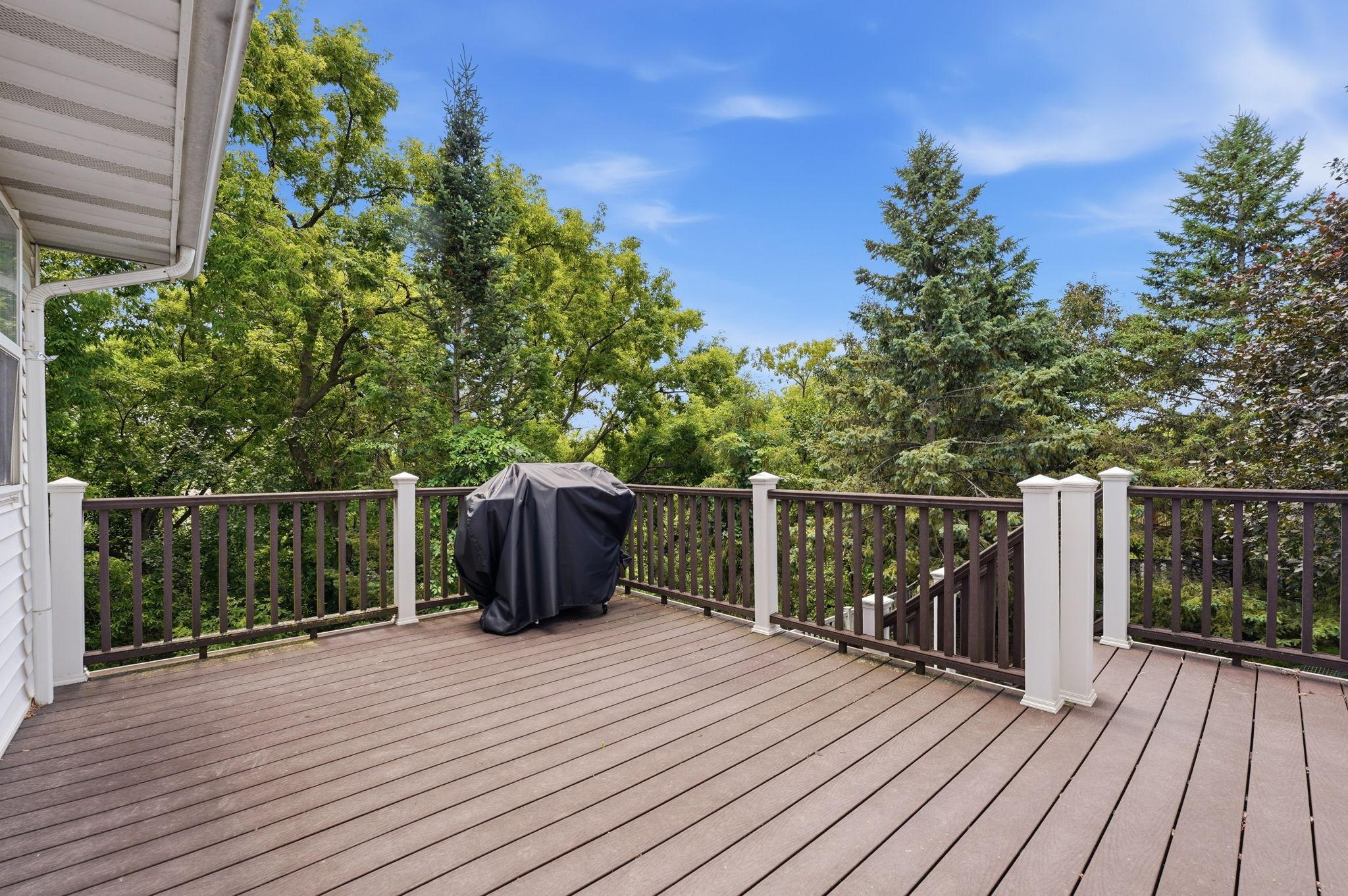Large Trex deck overlooking your private backyard, with steps leading down to the yard.