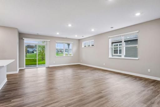 Large greatroom with kitchen, living room, and adjacent patio.