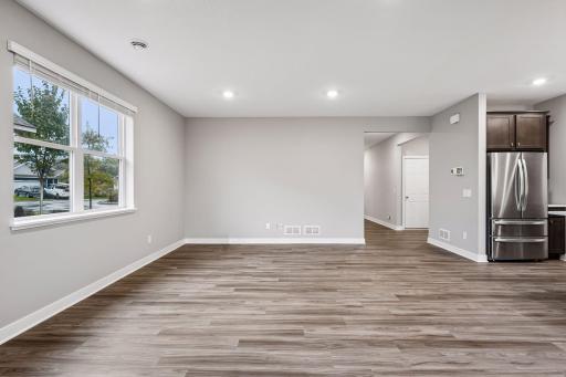Large greatroom with kitchen, living room, and adjacent patio.