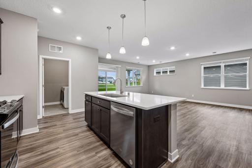 Large greatroom with kitchen, living room, and adjacent patio.