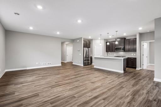 Large greatroom with kitchen, living room, and adjacent patio.