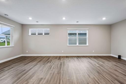 Large greatroom with kitchen, living room, and adjacent patio.