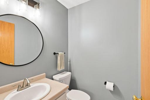 Main floor half bath just off the garage offers easy access.