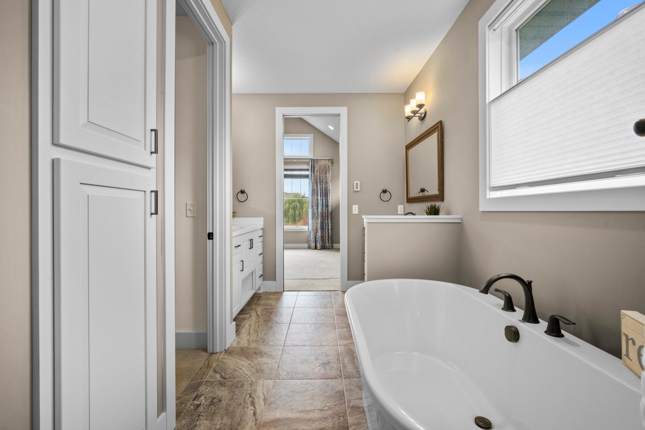 To the left of the tub is the walk in closet