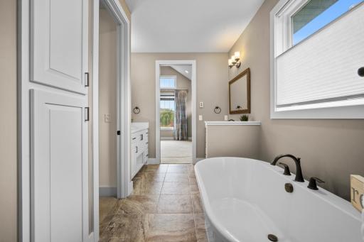 To the left of the tub is the walk in closet