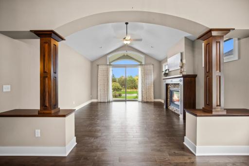 Huge main level living room with gas fireplace and walnut colored hardwood floors