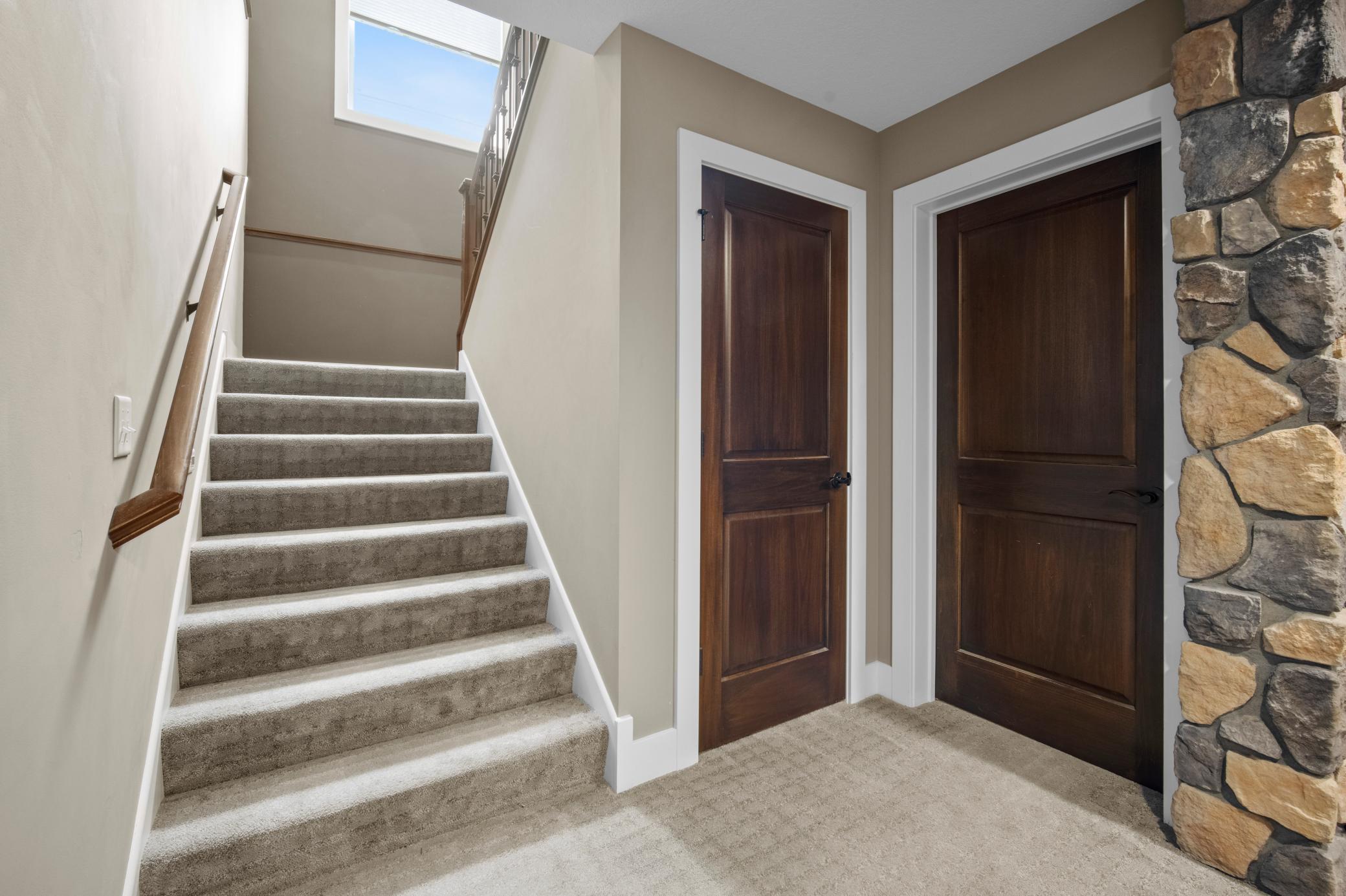 Extra wide staircase with lighting brings you to the lower level