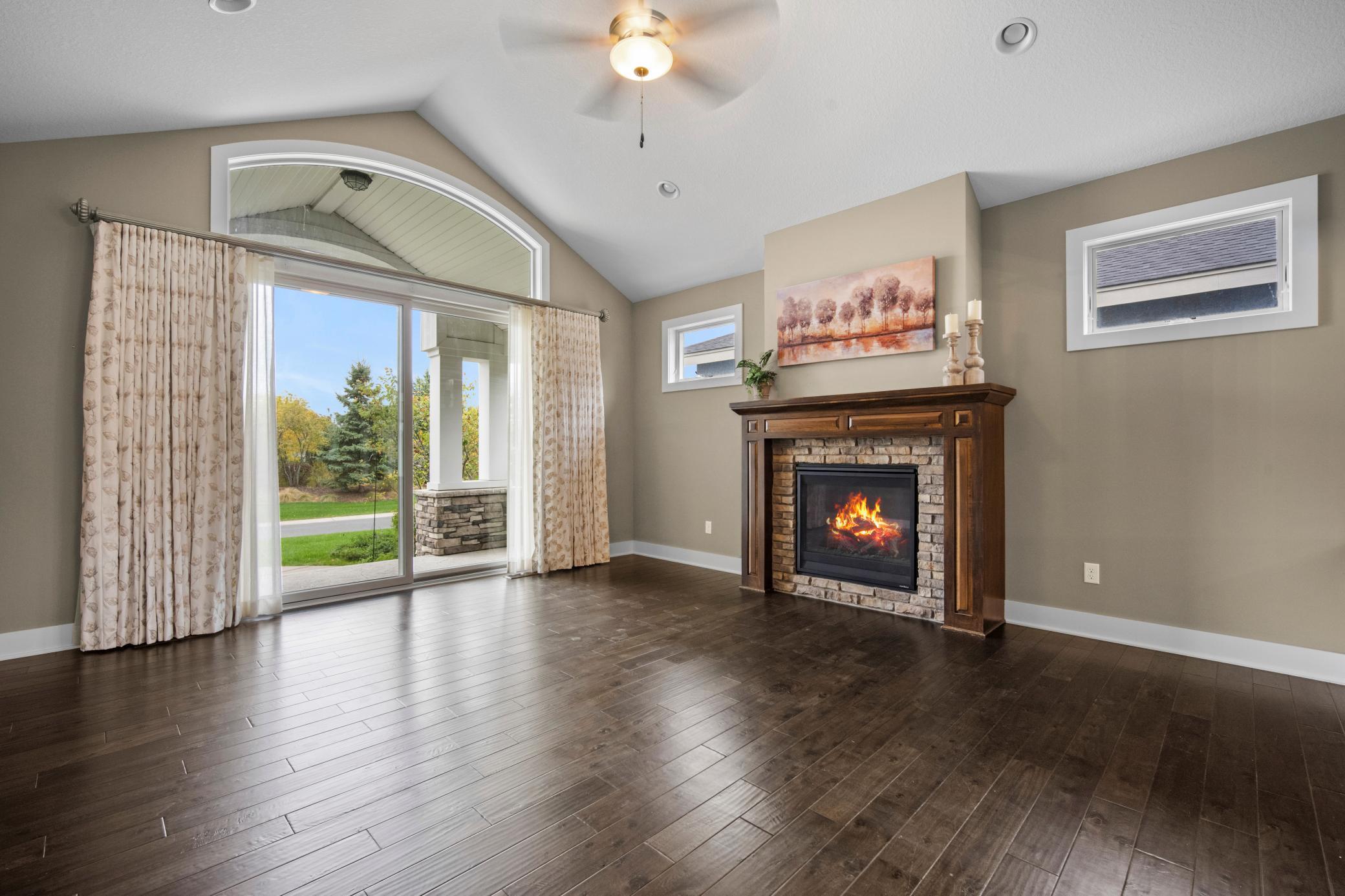 Living room has floor to ceiling sliding glass door that leads out to a covered back stamped concrete patio