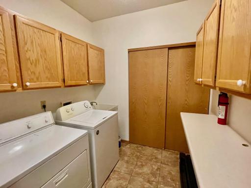 Laundry room with sink and includes washer and dryer