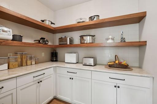 Butlerâs pantry with additional storage and counter space.