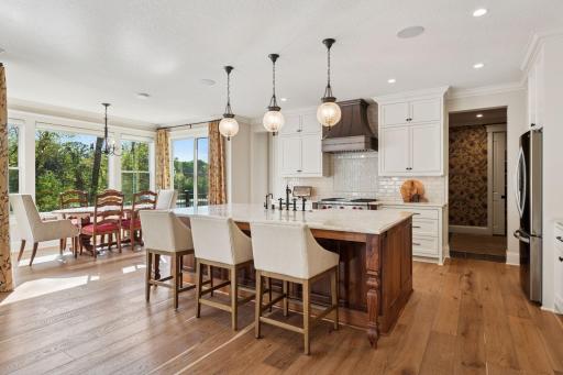 Gourmet kitchen boasting a center island w/apron sink & seating.