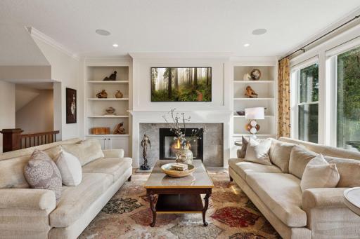 Wood burning fireplace and built-ins add to the incredible design.