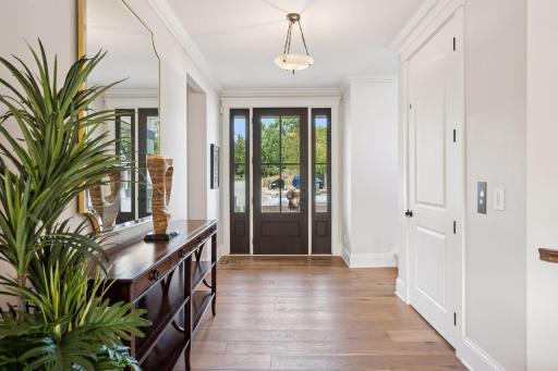 Welcoming front entry with convenient elevator servicing all levels.