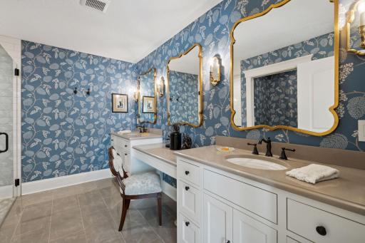 En-suite bathroom with dual vanities, tile shower & heated floors.